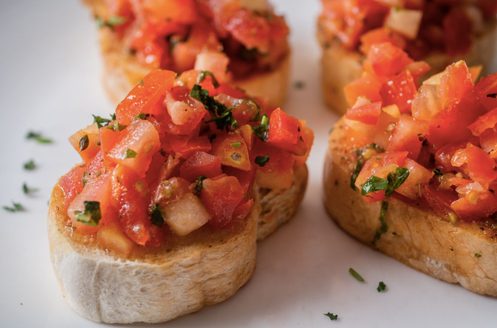 Bruschetta topped with marinated tomatoes